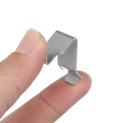Heavy Duty Metal Shelf Clips With Super Sturdy Adjustable Mounts For Closets And Bookshelves, held between fingers.