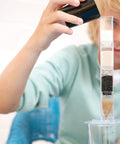 Child using Hands-On Desalination Kit For Kids And Teens A Cool Lab Grade Science Toy To Learn Climate Change Global Warming And Salt Removal.