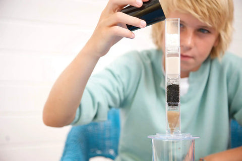 Child using Hands-On Desalination Kit For Kids And Teens A Cool Lab Grade Science Toy To Learn Climate Change Global Warming And Salt Removal.