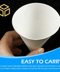 Hand holding a 50 Pack Disposable Paper Oil Funnels for Cars and Home, showing close-up of a 6oz Leakproof Auto Fluid Dispenser.