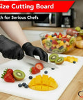 Pro Grade Commercial Plastic Cutting Board With Large 18 By 12 By Half Inch Thick White Poly Surface in use with sliced fruits.
