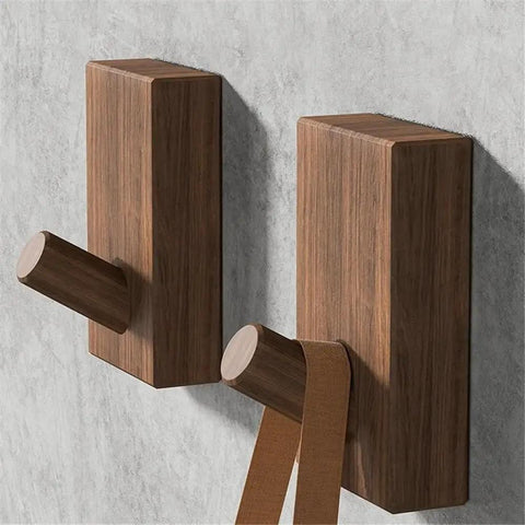 Modern Wall Mounted Coat Rack With Smooth Beige Finish Sleek Space Saving Design For Entryways with two hooks holding a strap.