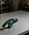 Ergonomic Manual Pipe Bender For Carbon Steel Water Gas Electrical Tubes, green metal tool on a work surface.