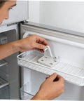 Person installing Rock Solid Metal Refrigerator Lower Hinge Assembly Two Piece Set for freezer door alignment.