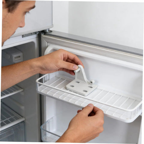 Person installing Rock Solid Metal Refrigerator Lower Hinge Assembly Two Piece Set for freezer door alignment.