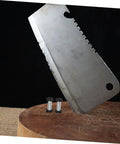 Badass Flat Head Knife Handle Screws And Brass Snap Rivets For Wood And Metal Crafts Tight Fit 2 Piece Kit next to a kitchen cleaver on wood.