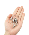 Heavy Hitter M6 Stainless Steel Spring Plungers 5 Pack Featuring Slick Pull Rings in hand for easy mounting on machinery.