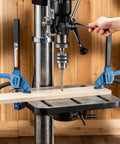 One Handed 10 Inch Bar Clamp With Spring Loaded Trigger Grip securing wood on drill press