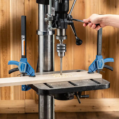 One Handed 10 Inch Bar Clamp With Spring Loaded Trigger Grip securing wood on drill press