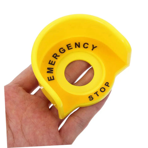 Hand holding yellow plastic guard for "2 Pack Stop Button Protective Covers For Emergency Stop Switches Industrial Plastic Guard To Prevent Accidental Activation Safety Shield For Machines Today"