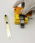 Using 147Pcs Watch Repair Tool Kit with Portable Case for Band Link Removal and Watch Maintenance, with gloves and yellow tool holder.