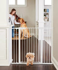 Extra Tall Walk Thru Pet Gate For Large Dogs With Adjustable Pass Through Door pressure mounted, white metal gate blocking entry.
