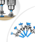 Six Floweringbeter carbide hinge-boring bits with blue tips and metal shanks; installed bit drilling into wood, set laid out.