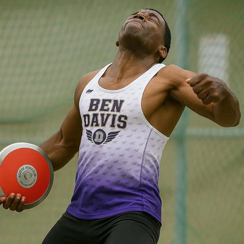 Athlete with 70 Percent Rim Weight Discus With Galvanized Steel Rim And ABS Plates, preparing for throw. Focused expression.