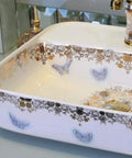 USZWBY Bathroom Sink, Countertop Basin Ceramic Ceramic Countertop Sink with gold floral design and butterfly accents.