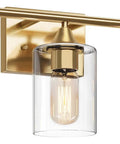 Brushed brass three light vanity light fixture with clear glass shades, ideal for bathroom mirror or kitchen use.