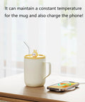 Cordless Smart Coffee Mug Warmer Plate With Digital Temperature Control Keeps Your Morning Brew Dialed In And Piping Hot Great For Office Desks Or Road Trips Say Goodbye To Sad Lukewarm Sips Always on a wooden table with a phone charging.