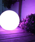 16 Inch Rechargeable LED Glowing Ball Light With Remote Waterproof Orb Lamp on patio with purple flowers at night