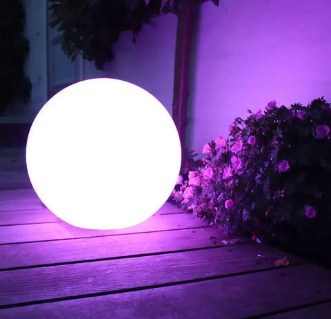 16 Inch Rechargeable LED Glowing Ball Light With Remote Waterproof Orb Lamp on patio with purple flowers at night