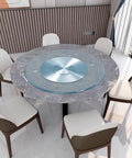 40 Inch Rotating Lazy Susan Turntable Made From Tempered Glass placed on a round dining table with chairs