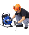Person using Heavy Hitter Electric Drain Auger Machine With Sixty Foot Cable And Four Cutter Heads For Knocking Out Tough Clogs In One To Four Inch Pipes With No Sweat Foot Switch.