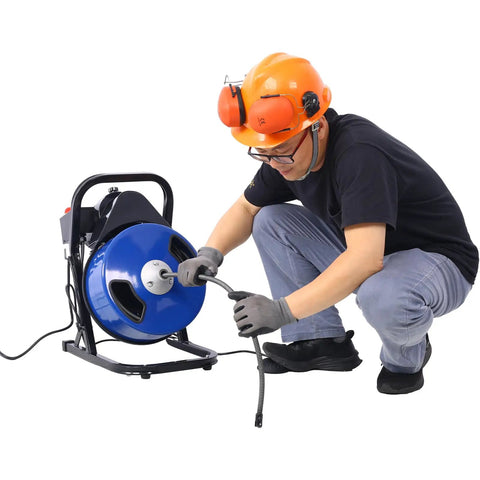 Person using Pro Grade Electric Drain Auger With 60 Ft Flexible Wire Cable to clear a clog from a pipe.