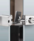 Hella Secure Stainless Steel Glass Door Lock With Double Bolt Build And Sleek Push Slider Mechanism For Eight To Twelve Millimeter Frames Quick Office Install Arrives With Three Sturdy Keys For Ultimate Peace, detailed view of lock installed on glass.