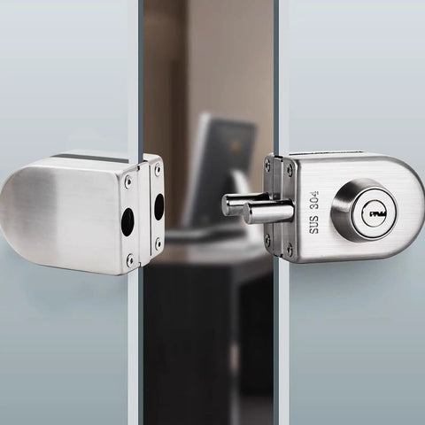Hella Secure Stainless Steel Glass Door Lock With Double Bolt Build And Sleek Push Slider Mechanism For Eight To Twelve Millimeter Frames Quick Office Install Arrives With Three Sturdy Keys For Ultimate Peace, detailed view of lock installed on glass.
