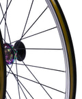 Close-up of 27 5 inch mountain bike wheel set with aluminum alloy rim and colorful hub, showing disc brake mount and quick release skewer.