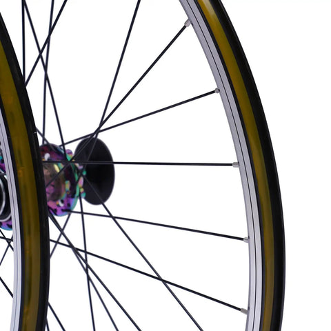 Close-up of 27 5 inch mountain bike wheel set with aluminum alloy rim and colorful hub, showing disc brake mount and quick release skewer.