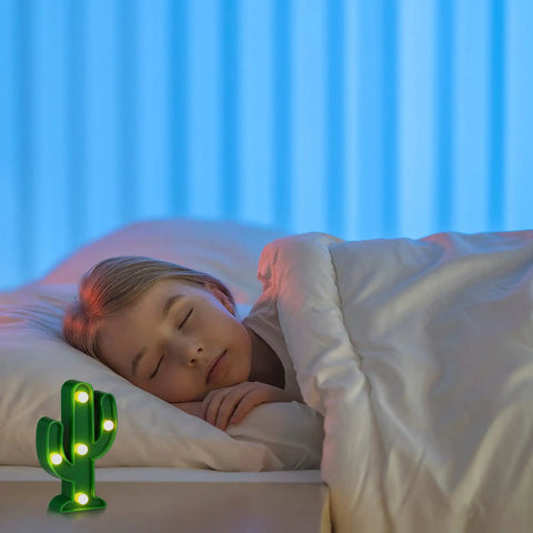 Child sleeping beside 2 Pcs LED Night Light Cactus Lamp Set For Table Desk Bedroom And Home Decor on bedside table.