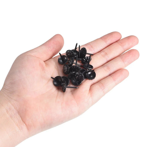 Top Tier Black Upholstery Tack Nail Pins Heavy Carbon Steel Furniture Repair Kit 50 Piece in hand, showcasing 17mm length black decorative tacks.