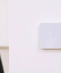 White ZigBee Edition Smart Thermostat on wall showing 72 degrees, easy comfort control, compatible with SmartThings SwannOne Securifi Almond hubs
