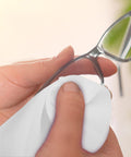 Hand using a Straight Up Spotless With This Reusable Eyeglass Cleaning Cloth Nano Dust Free Microfiber Wiper to clean glasses.