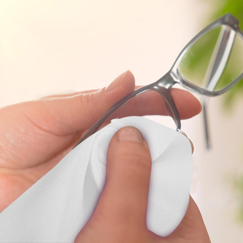Hand using a Straight Up Spotless With This Reusable Eyeglass Cleaning Cloth Nano Dust Free Microfiber Wiper to clean glasses.