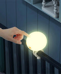 Hand touching Rechargeable Jellyfish LED Night Light For Nursery With Dimmable Touch Control 1800mAh Battery on crib mount