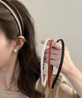 Premium Skinny Leather Headbands For Women Five Piece Set held in hand, featuring soft top grain leather in neutral colors.
