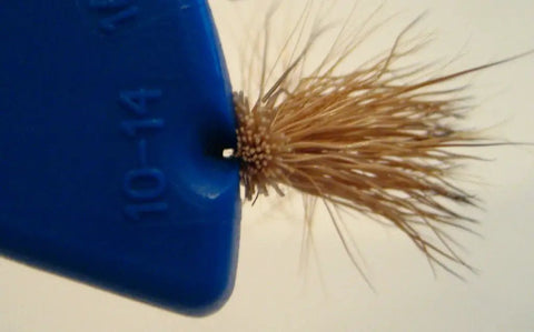Close-up of Eye Tie Fly Threader With Magnetic 3 Funnel System holding a fly hook aligned in slot marked 10-14.