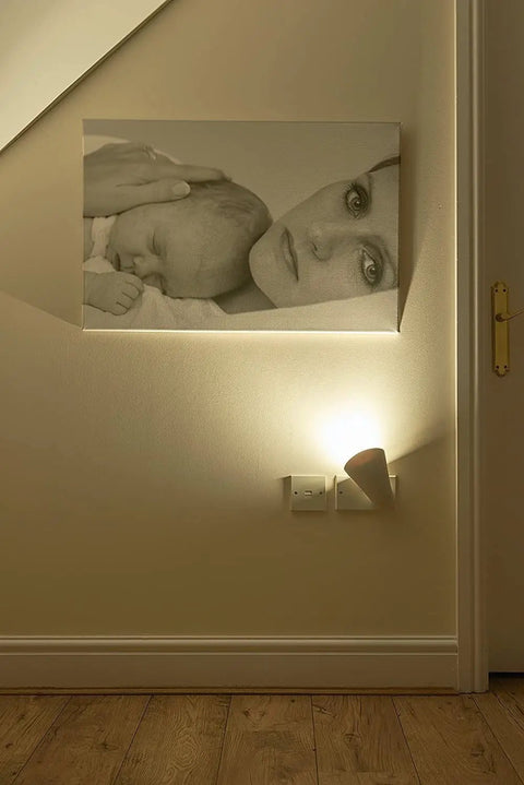 Plug In Wall Sconce Uplighter With GU10 Spotlight Wash Light illuminating wall art in cozy ambient glow