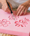 Afantti 31 Piece Electric Hot Knife Foam Cutter Kit With 23 Plastic Cutting Blades Adjustable Temperature Up To 500 Celsius For Styrofoam Craft And Fabric Precision Tool, cutting pink foam into flower shapes.
