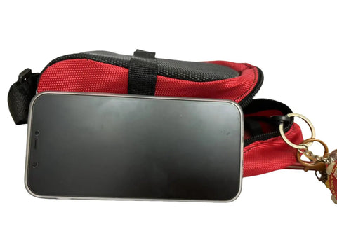 Waterproof Bike Saddle Bag For Mountain And Road Bikes With Built In Keychain Easy Install Seat Pack in red holding a smartphone