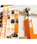 Premium Game Changer Complete Sliding Barn Door Hardware Featuring No Sweat Floor Roller Installation With Smooth Gliding Stainless Steel Track in modern loft with orange ladder.