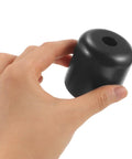 Hand holding a Dope Black Screw-In Furniture Leg from the 4 Pack for sofas, chairs and dressers, modern sleek 2 inch height replacement foot.