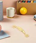 Vintage Zinc Alloy Cabinet Pull Handles 10 Pack For Wardrobes And Drawers with gold finish shown on a desk with craft supplies