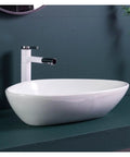 Bathroom Sink Ceramic Art Basin Large Size Creative Triangle Above Counter Basin with smooth white finish and modern faucet.