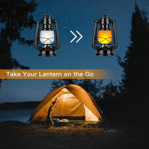 Battery Operated LED Vintage Lanterns With Remote shown in front of a lit camping tent, showcasing flickering flame effect.