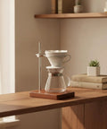 Premium Solid Wood Pour Over Stand with glass carafe and dripper on wooden counter, 6.5x4.9x8.7 inches, for coffee brewing.