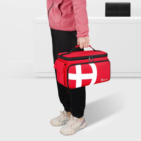 Mancro red first aid travel bag with multiple pockets; front view shows white cross design and Mancro logo visible.