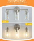 Three Light Bathroom Vanity Light Fixture in Brushed Nickel with Clear Glass Shades over Mirror Wall Sconce, dim lighting display
