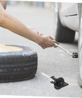 Spare Tire Bolt Hold Down Retainer Bracket For Car Wheels Easy Install No Fuss Universal Tire Retainer Clamp shown during tire change.